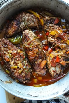 a pot filled with meat and vegetables on top of a stove