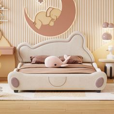 a child's bedroom decorated in pastel colors with pink accents and an elephant on the bed