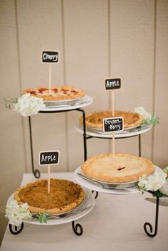 there are three pies on the table with little signs for each one to eat