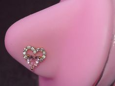 a fake breast with a heart shaped diamond ring on it