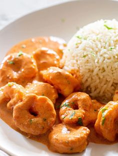 a white plate topped with rice and meat