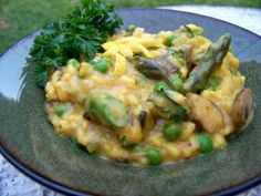 a green plate topped with rice and asparagus