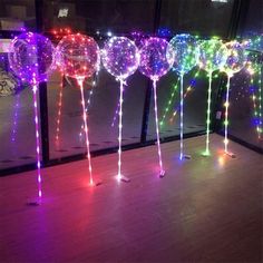 lighted balloons are lined up on the floor