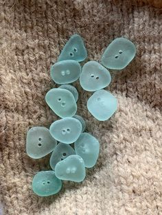 several glass buttons laying on top of a rug