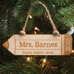 an ornament hanging from a christmas tree with the name mrs barnes on it