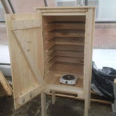 a small wooden cabinet with an electronic device inside