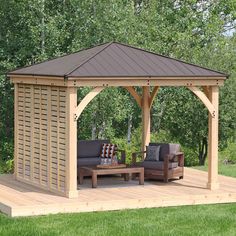 a wooden gazebo sitting on top of a lush green field