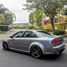 a silver car is parked on the street