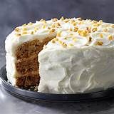 a cake with white frosting and yellow sprinkles on top is sitting on a plate