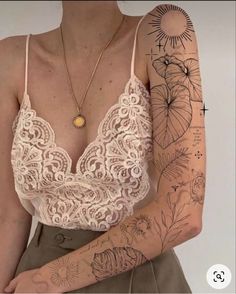 a woman with tattoos on her arm and chest