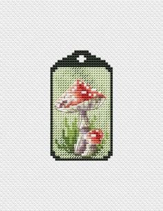 a cross stitch pattern with mushrooms in a jar