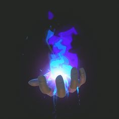 a person holding a glowing object in their hand with blue and purple light coming out of it