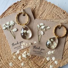 two thank you cards with flowers in them on a piece of paper next to some dried flowers