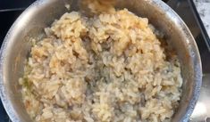 a pot filled with rice on top of a stove