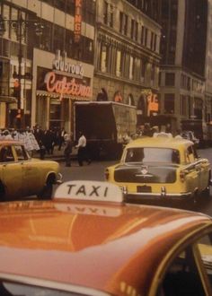 taxi cabs and taxis on a busy city street