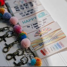 several key chains with pom - poms attached to them