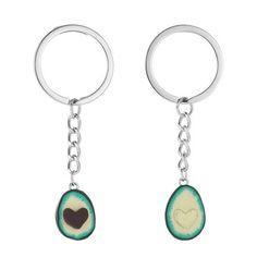 two key chains with heart shaped charms hanging from it's sides, one is green and the other is brown