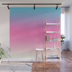 a pink and blue ombreed wall mural in a living room