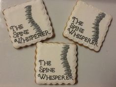 three decorated cookies with the words, the spine whisperer and the spines on them