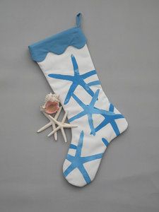 a white and blue christmas stocking with starfishs on it's side