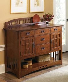 a wooden sideboard with drawers and baskets on top