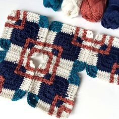 several crocheted squares are laid out on the table