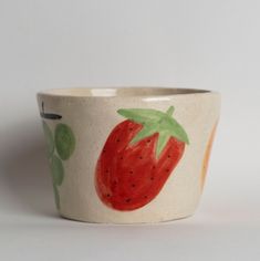 a ceramic bowl with a strawberry painted on it