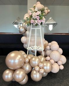 an arrangement of balloons and flowers on display