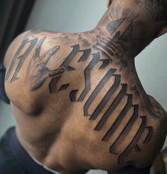 the back of a man's neck with an arrow and arrows tattoo on it