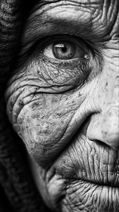 black and white photograph of an old woman's face with wrinkles on her eyes