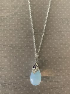 "Lovely moonstone white teardrop shaped necklace featuring silver tone regal motif with purple inlaid gem stone. Pendant measures 7/8\" L X 1/2\" W and is on an 18\" chain. Note: This is a slightly smaller version of this necklace sold prior to 6/30/20. Also available with a black stone under the following listing: https://www.etsy.com/listing/858843851/moonstone-necklace-moon-stone-necklace?ref=listings_manager_grid ★ Want to see more? Please visit my shop at: https://www.etsy.com/shop/DesignsB Luxury Moonstone Necklace With Moon Charm, Cheap Adjustable Purple Crystal Necklaces, Luxury Moonstone Gemstone Necklace, Luxury Moonstone Necklace, Adjustable Purple Crystal Necklaces, Cheap Purple Necklace With Round Pendant, Large Moonstone Necklace, Luxury White Moonstone Necklaces, Luxury Moonstone Cabochon Necklace