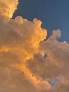 an airplane is flying in the sky at sunset