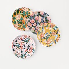 three paper plates with floral designs on them