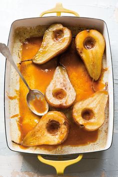 an image of food in a pan with spoons on the side and apples cut into pieces