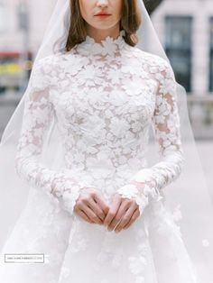 a woman wearing a wedding dress and veil