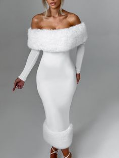 a woman wearing a white dress and fur stole