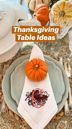 a thanksgiving table setting with pumpkins and other decorations on the placemat, along with napkins