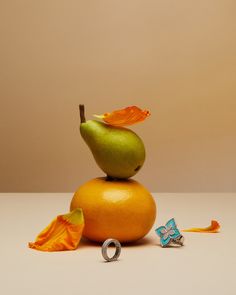 an orange and green apple sitting on top of each other next to the word love