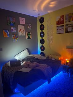 a bedroom with blue lights and pictures on the wall