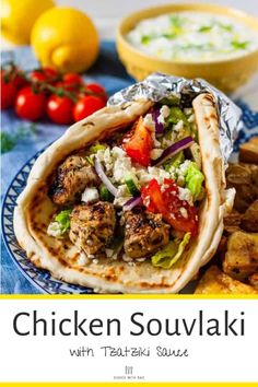 chicken souvlaki with greek sauce is shown on a blue and white plate