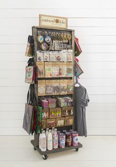 a display case filled with lots of items on top of a wooden floor next to a white wall