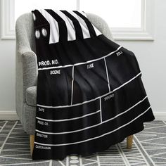 a black and white blanket sitting on top of a chair