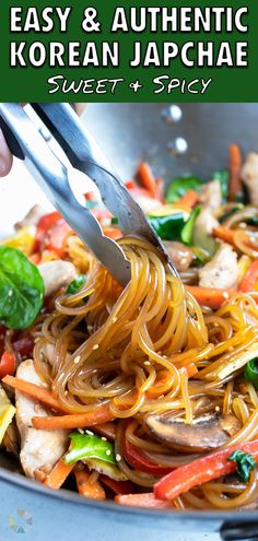 someone is using tongs to stir noodles in a wok with vegetables and chicken