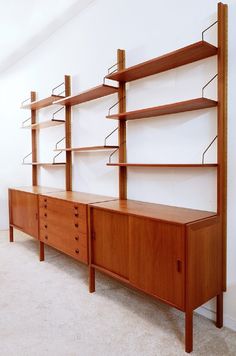 an empty room with some wooden shelves on the wall