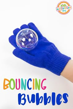 a blue glove with the words bouncing bubbles on it and a hand holding a soap ball