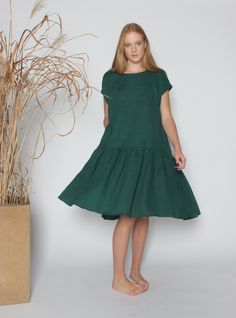 Custom orders and items purchased during major sales cannot be returned or exchanged. Oversized loose dark green linen dress is the perfect casual everyday dress for hot summer days. It will be a great choice for walking at the beach or just relaxing at home with your friends and family. Style with flats for a cool effortlessly look. This linen dress is ideal for women who wear plus size because of a relaxed fit. Since the dress is loose and comfy, it will also be a great choice as a maternity d Dark Green Knee-length Summer Dress, Dark Green Knee-length Midi Dress For Summer, Casual Dark Green Short Sleeve Dress, Casual Green Midi Linen Dress, Green Linen Knee-length Midi Dress, Green Midi Linen Dress, Beach Green Linen Midi Dress, Green Linen A-line Midi Dress, Green A-line Linen Midi Dress