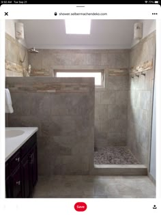 a bathroom with a walk in shower sitting next to a sink and toilet under a window