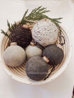 a bowl filled with ornaments on top of a table