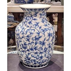 a blue and white vase sitting on top of a table