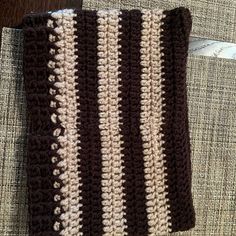 a brown and white crocheted dish cloth